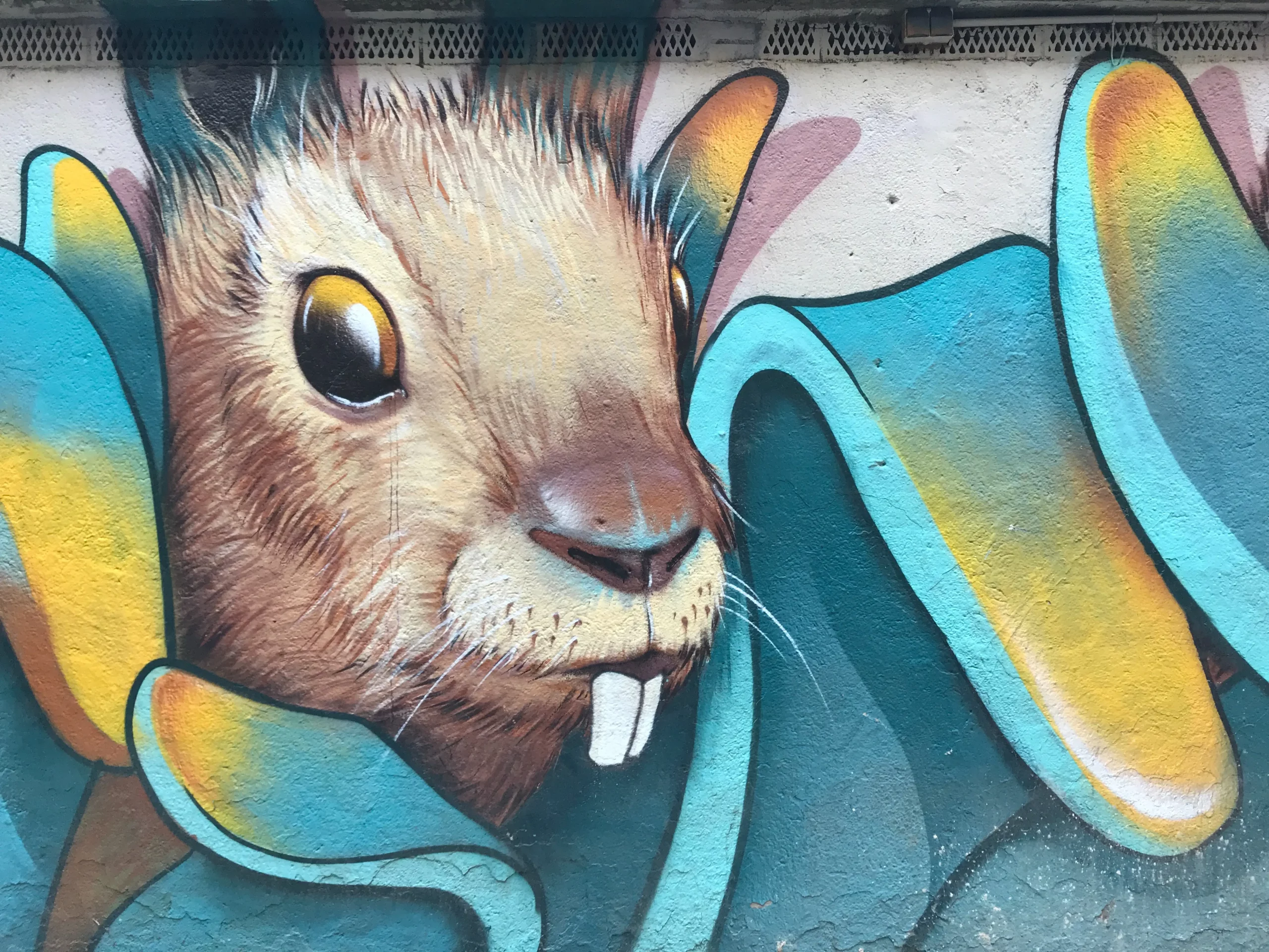 Ein brauner Hase der an eine Gebäudefassade gemalt wurde.
